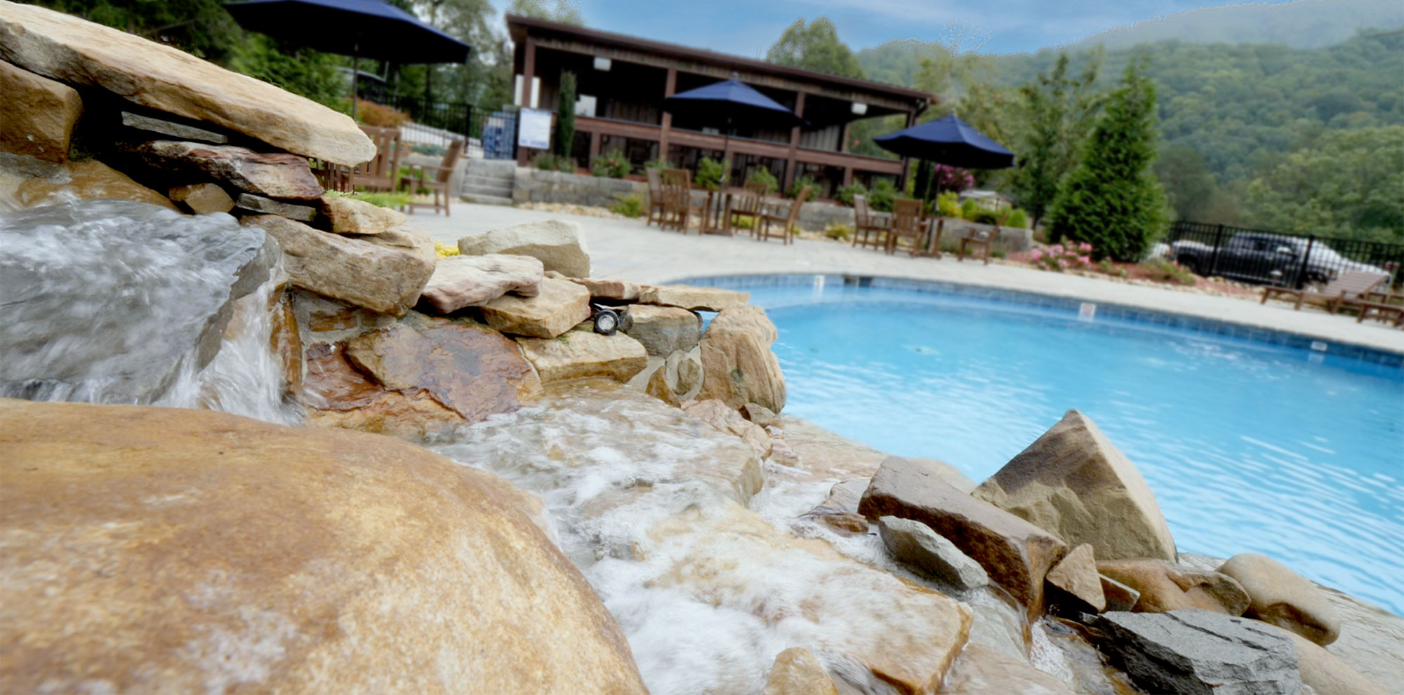 Rock Ridge Resort pool and waterfall with mountain backdrop